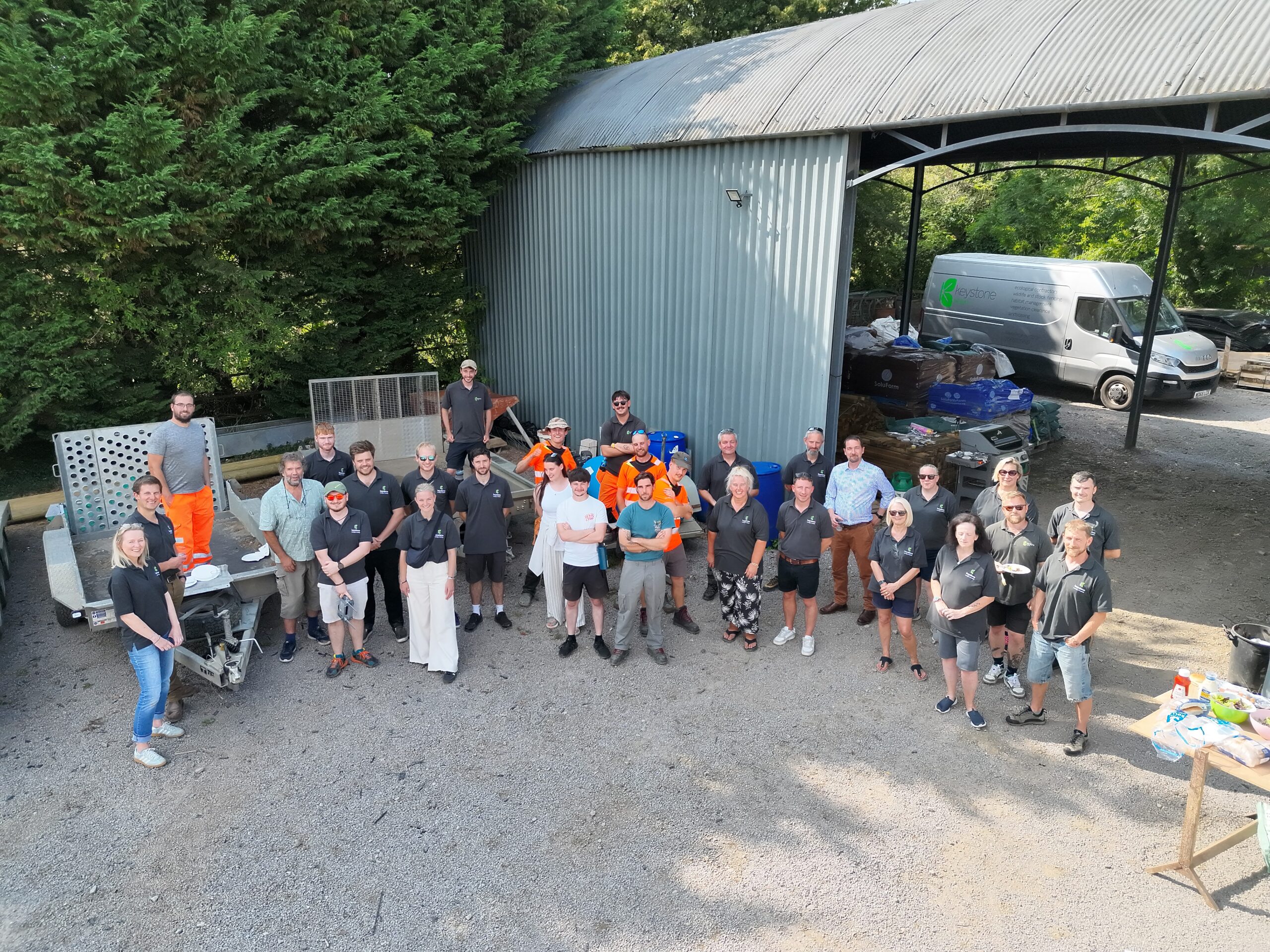 Drone shot of the Keystone Team standing next to an open barn